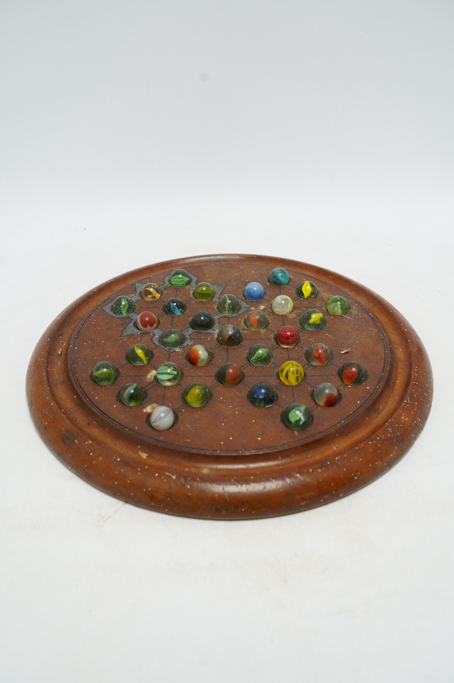 A Victorian circular mahogany solitaire board, 30cm diameter, together with a Victorian mahogany instrument box, 26cm high. Condition - fair